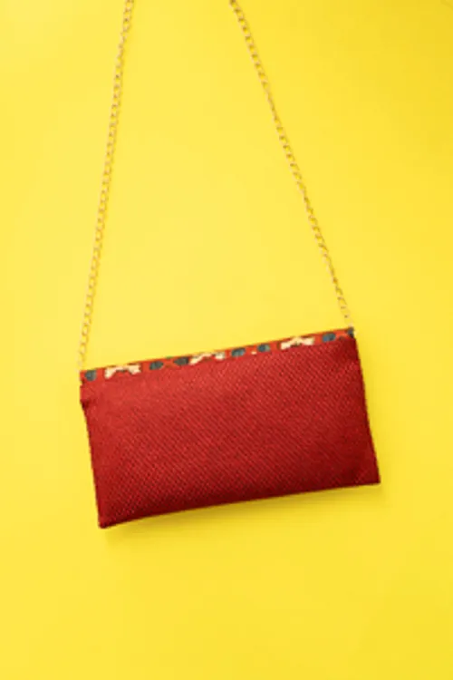 Red silk ikkat print sling clutch